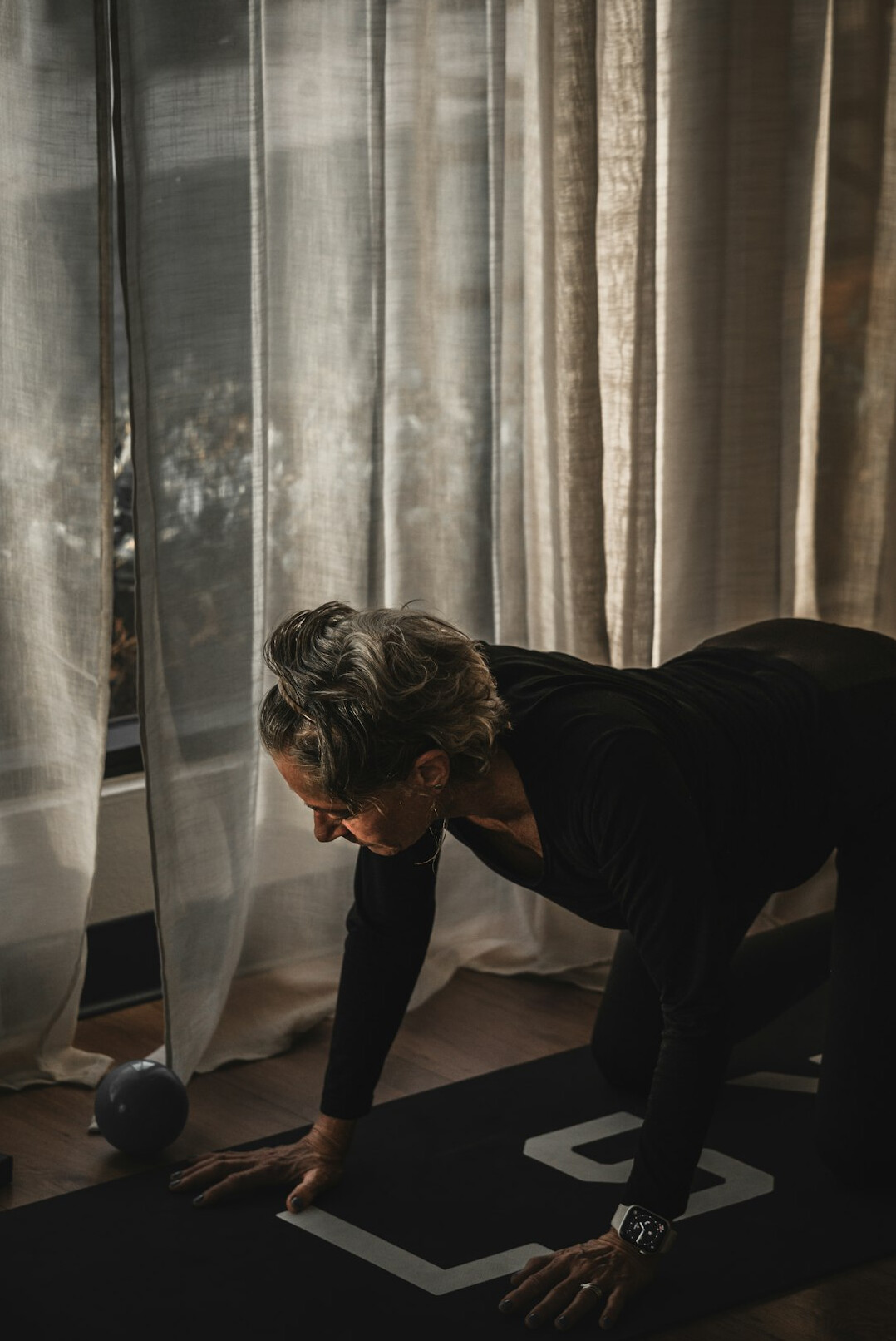 senior woman doing yoga at home