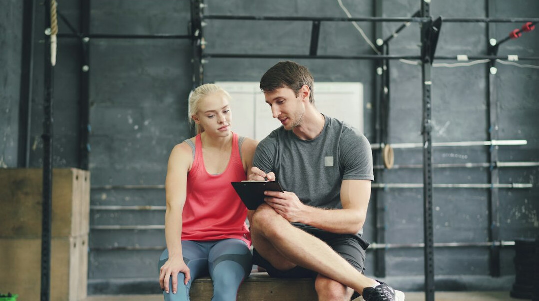 senior with personal trainer