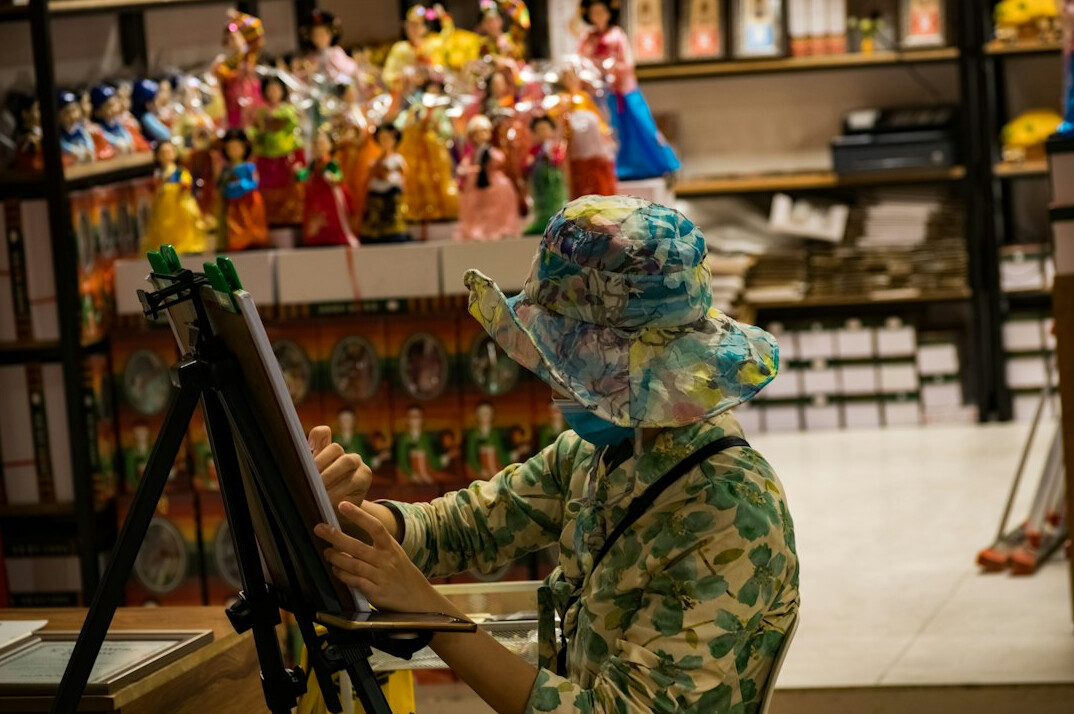senior woman painting in class