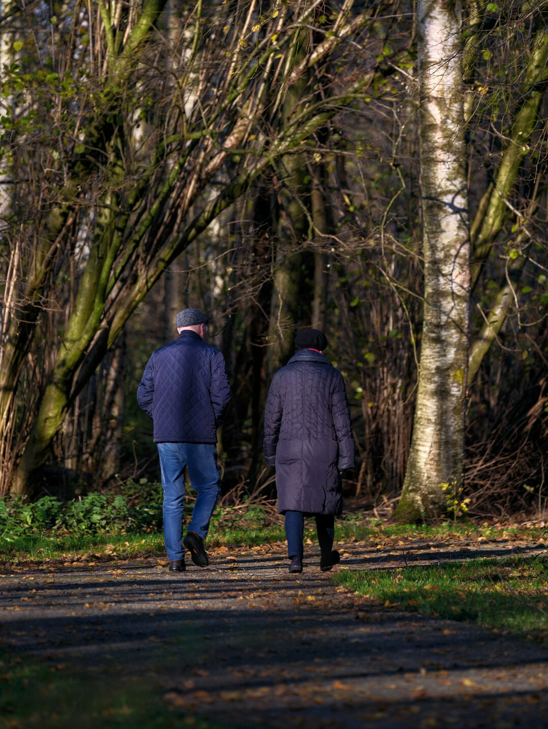 senior couple walking in park